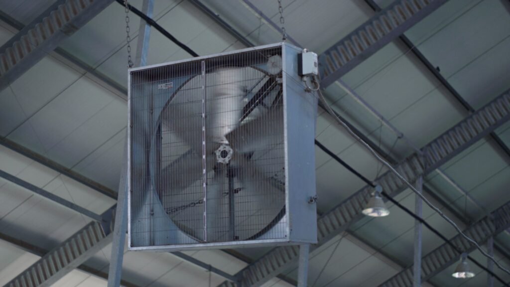 Aeration fan attached to a grain storage bin on a US farm used to cool corn and prevent moisture migration