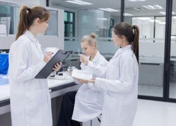 Laboratory assessor reviewing ISO IEC 17025 accreditation documentation for analytical balance calibration program during laboratory audit