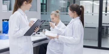 Laboratory assessor reviewing ISO IEC 17025 accreditation documentation for analytical balance calibration program during laboratory audit