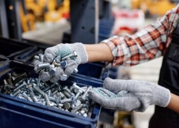 Screws and fasteners to be counted by weight with Industrial parts counting scale on a factory bench