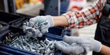 Screws and fasteners to be counted by weight with Industrial parts counting scale on a factory bench