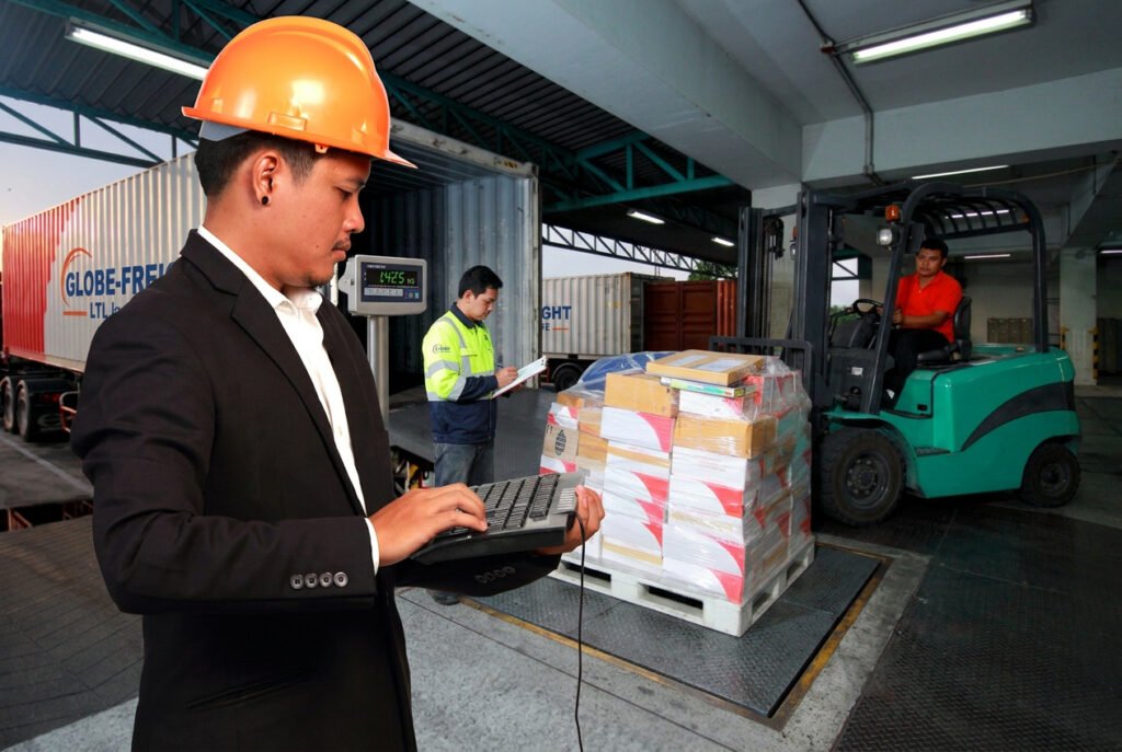 Loaded pallet being weighed on a heavy duty floor scale at a warehouse freight shipping dock before LTL carrier pickup