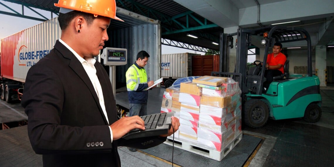 Pallets of freight being loaded onto an LTL carrier truck at a warehouse shipping dock