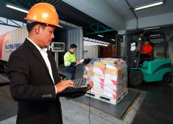 Pallets of freight being loaded onto an LTL carrier truck at a warehouse shipping dock