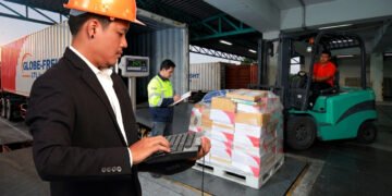 Pallets of freight being loaded onto an LTL carrier truck at a warehouse shipping dock