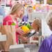 Grocery store checkout lane with an integrated POS scale platform at the register weighing fresh produce during a customer transaction