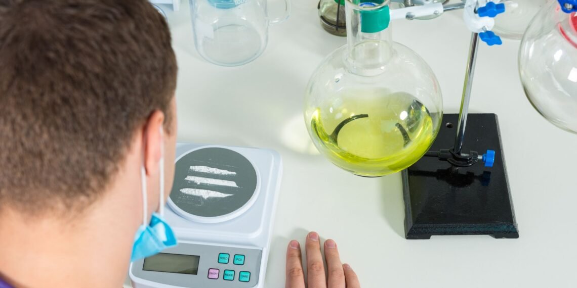 Analytical balance placed on an anti-vibration table in a controlled laboratory environment away from drafts and vibration sources
