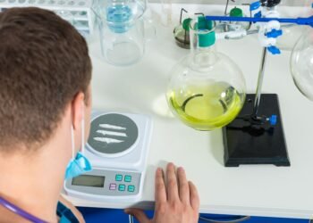 Analytical balance placed on an anti-vibration table in a controlled laboratory environment away from drafts and vibration sources