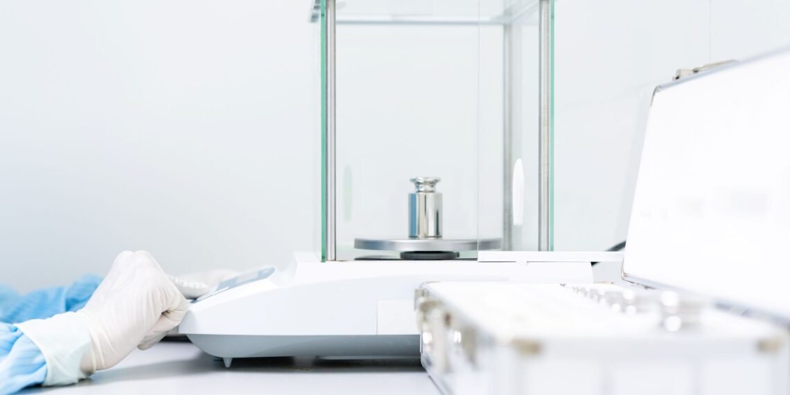 Laboratory analyst performing a ten-replicate precision verification test on an analytical balance using a certified reference weight