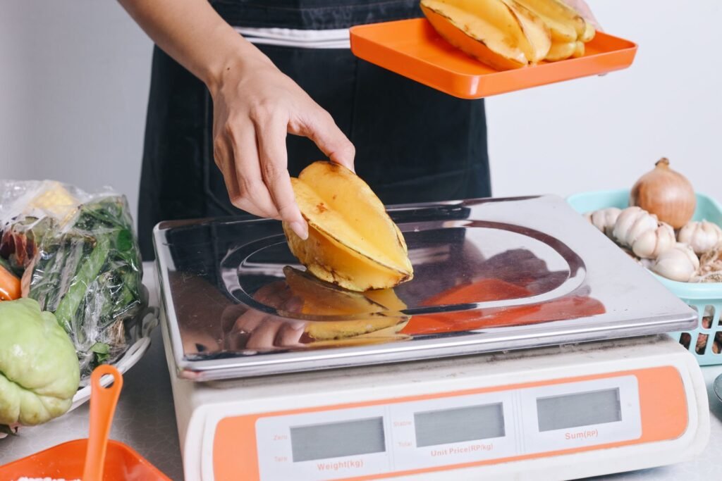Removable stainless steel platform being cleaned on a deli counter scale showing NSF-certified food-safe construction