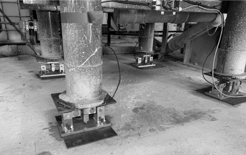 Industrial hopper scale with load cells mounted at vessel support points for continuous batch weighing and ingredient verification in food manufacturing