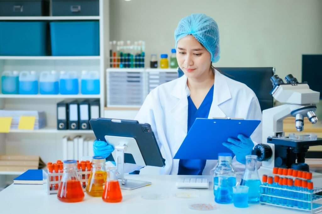 Laboratory analyst following a standard operating procedure document for analytical balance calibration in a GMP pharmaceutical quality control environment