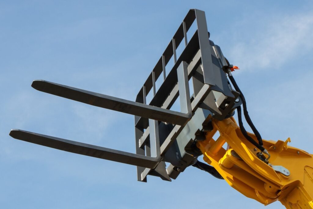 Load cell carriage scale mounted between forklift mast and forks showing precision weight measurement system for legal-for-trade warehouse applications