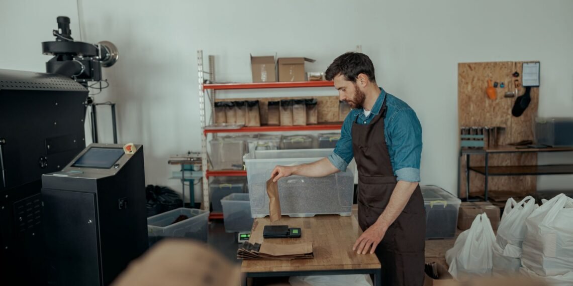 Digital parcel scale at an e-commerce packing station with packages ready for carrier pickup and shipping label printing
