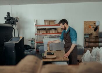Digital parcel scale at an e-commerce packing station with packages ready for carrier pickup and shipping label printing