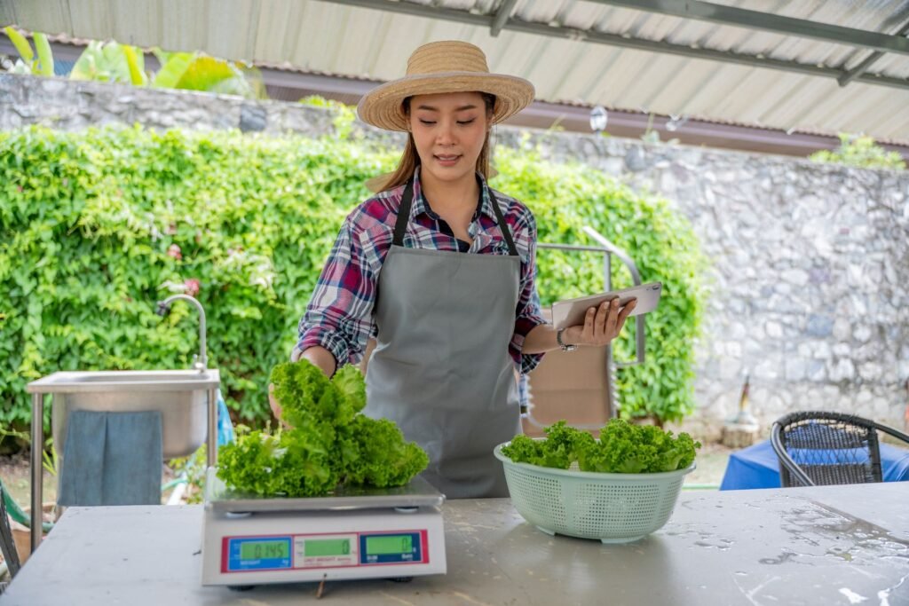 Portable battery-powered NTEP-certified price computing scale at a farmers market produce stand with dual display visible to customer