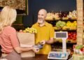 Deli counter operator using an NTEP certified price computing scale to weigh and price food products for a customer in a retail grocery store