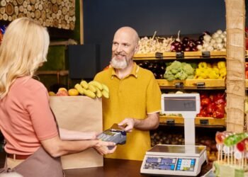 Deli counter operator using an NTEP certified price computing scale to weigh and price food products for a customer in a retail grocery store