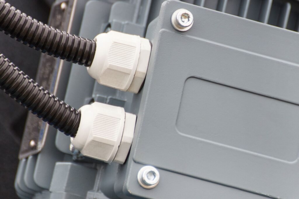 Sealed industrial scale load cell and junction box with IP67 rated cable entries installed under a floor scale platform