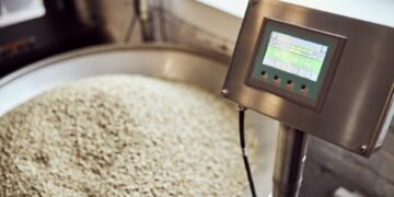 Stainless steel industrial floor scale in a food processing facility showing corrosion-resistant platform suitable for washdown cleaning