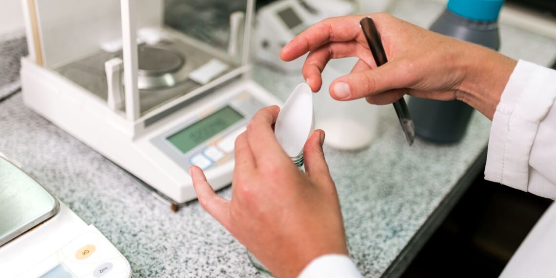 Top loading balance with open pan next to an analytical balance with enclosed draft shield on a laboratory bench for side by side comparison