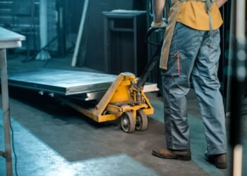 Heavy duty industrial floor scale with diamond plate deck in a US warehouse with pallets loaded by forklift