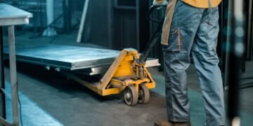 Heavy duty industrial floor scale with diamond plate deck in a US warehouse with pallets loaded by forklift