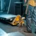 Heavy duty industrial floor scale with diamond plate deck in a US warehouse with pallets loaded by forklift