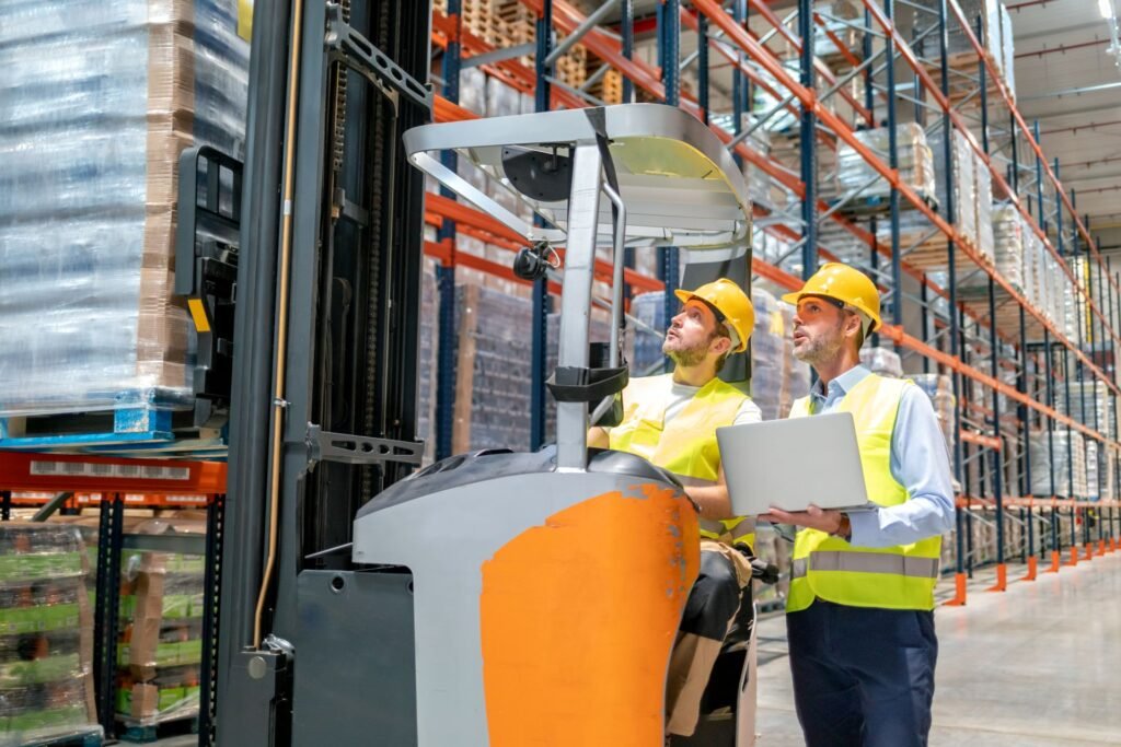 Forklift operator viewing pallet weight reading on cab-mounted scale indicator connected to warehouse management system