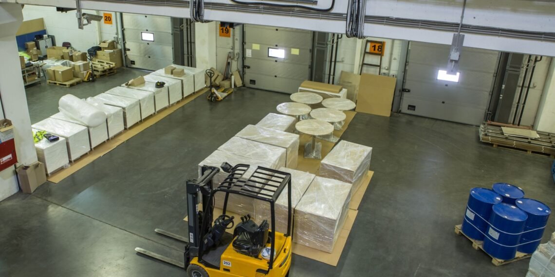 Warehouse distribution center receiving dock with floor scale for inbound pallet weight verification and outbound freight weighing operations
