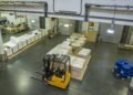 Warehouse distribution center receiving dock with floor scale for inbound pallet weight verification and outbound freight weighing operations