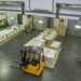 Warehouse distribution center receiving dock with floor scale for inbound pallet weight verification and outbound freight weighing operations